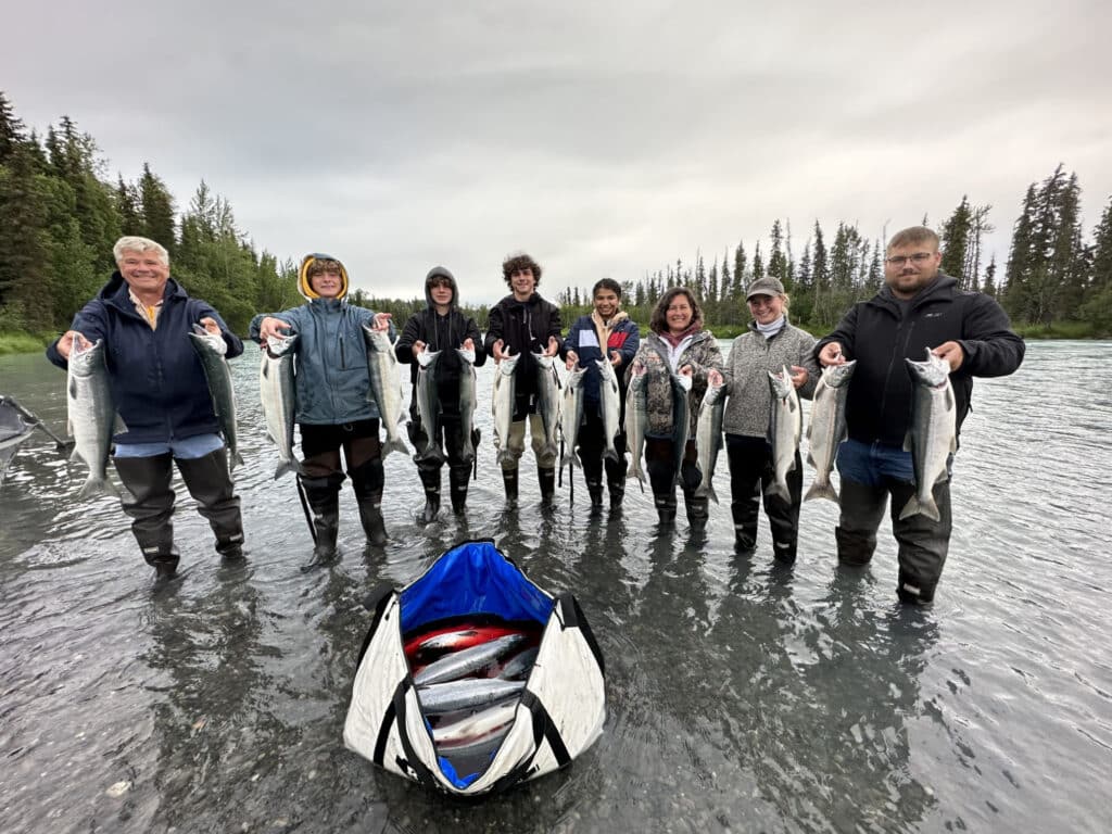 Kenai Drift Anglers guiding sockeye fishing on the Kasilof River in June, Alaska – Soldotna’s best fishing guide experience with anglers holding fresh reds in a scenic June river setting
