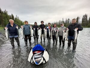 Kenai Drift Anglers guiding sockeye fishing on the Kasilof River in June, Alaska – Soldotna’s best fishing guide experience with anglers holding fresh reds in a scenic June river setting